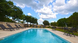 A rectangular swimming pool with clear blue water, surrounded by stone walls and shaded by trees. - Tranquil Getaway With Shared Pool in Bale (Bale)