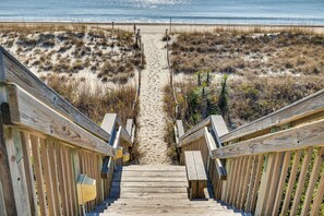 A wooden staircase leading to a sandy beach with a wooden railing on both sides. - Walk to Beach: Emerald Isle Condo w/ Ocean View! (Emerald Isle)