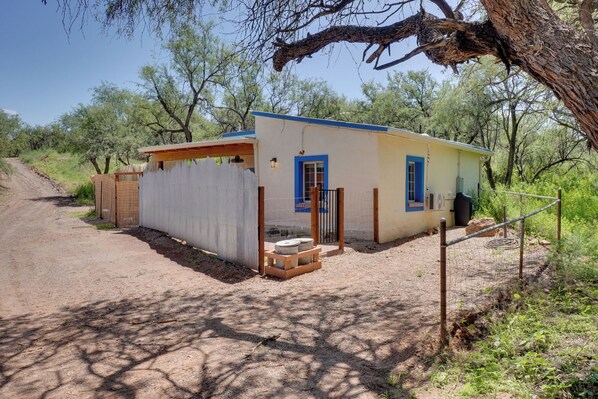 A small, single-story building with a blue door and a covered porch. - Peaceful & Historic Home in Patagonia! (Patagonia)