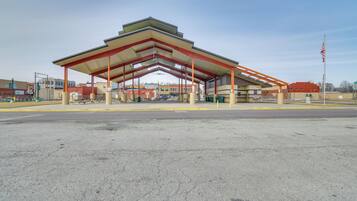 A gas station with a large canopy and multiple fuel pumps.