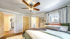 A bedroom with a bed, a ceiling fan, and a window with curtains. - < 1 Mi to Houlton Riverfront Park: Home w/ Yard! (Houlton)