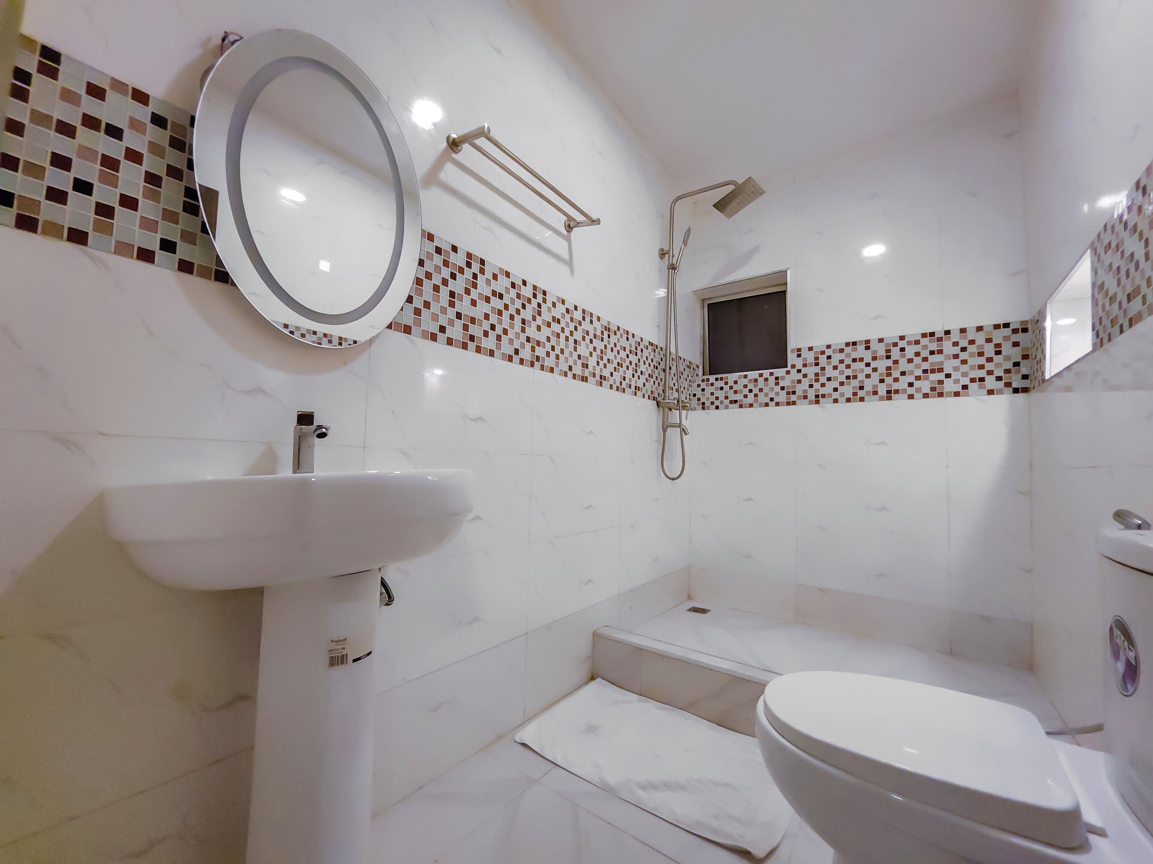 A bathroom with a sink, toilet, and shower.