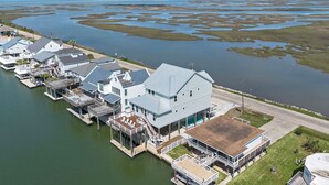 A waterfront property with multiple buildings, docks, and a large body of water.