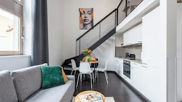 Classic Apartment, Balcony, City View | Living area | 50-inch LED TV with cable channels