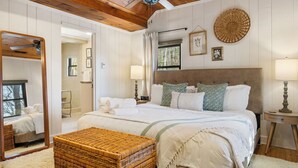A bedroom with a large bed, a mirror, a ceiling fan, and a window. - Hottub/Arcade/Historic Cabin/Mins to AVL & WVL (Weaverville)