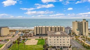 A coastal hotel with multiple buildings, a parking lot, and a view of the ocean. - Ocean View l 5BR l Pool l Sleeps 16 l Luxury Villa (north myrtle beach)