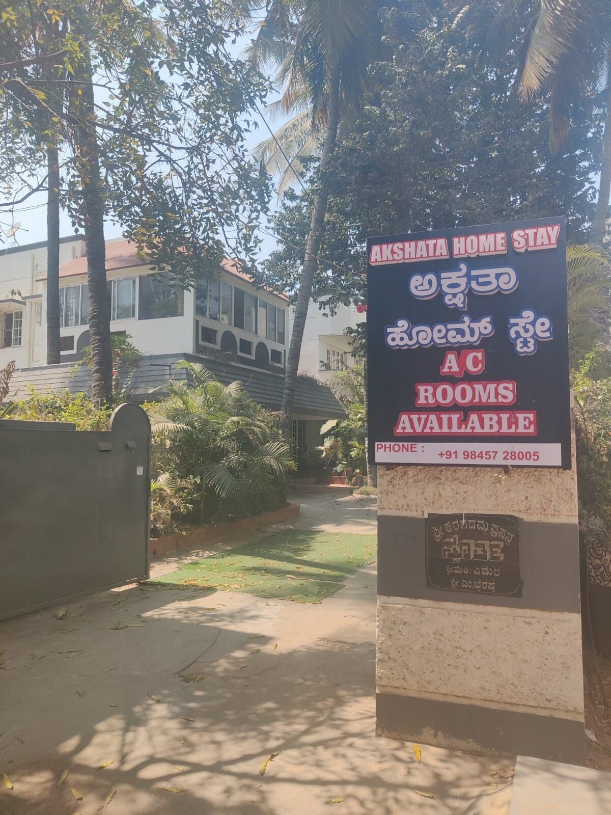 A signboard advertising AC rooms available at Akshata Home Stay.