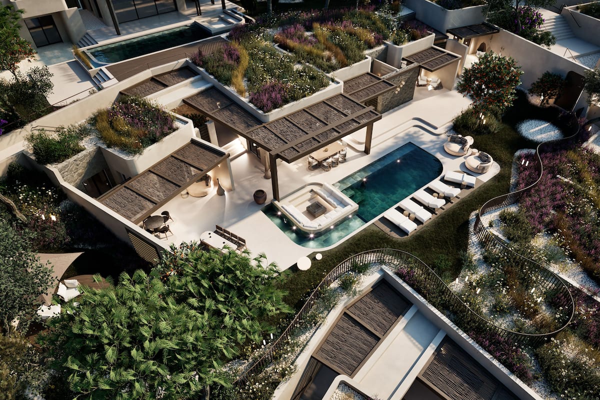 A modern outdoor pool area with a sun terrace, lounge chairs, and a small seating area.