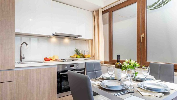 A modern kitchen with a dining area. - Modern Comfort With Shared Pool & Lush Green Surroundings in Kastav (Kastav)