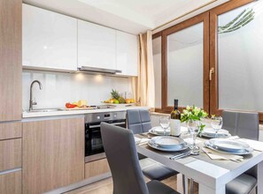 A modern kitchen with a dining area. - Modern Comfort With Shared Pool & Lush Green Surroundings in Kastav (Kastav)
