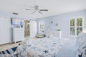 A ceiling fan keeping you comfortable, plantation shutters for privacy, and an en-suite bath with a barn door adding charming character.