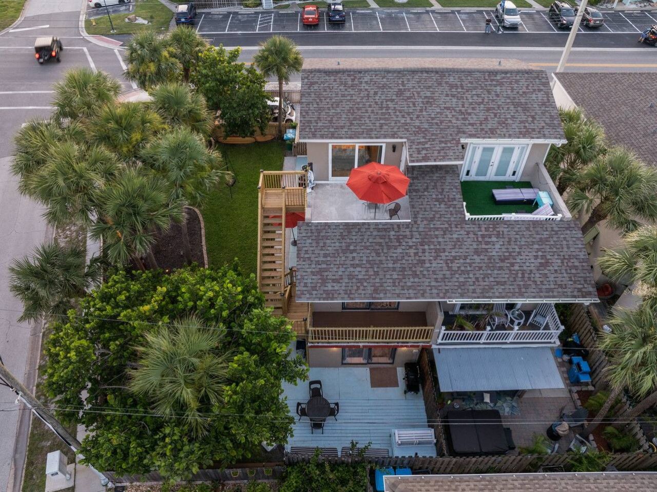 A residential property with a two-story house, a covered patio, and a fenced yard.