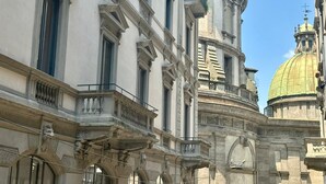 A historic building with classical architecture, including ornate balconies and a prominent dome. - Casa Milano Classic Elegance with Balcony (Milan)