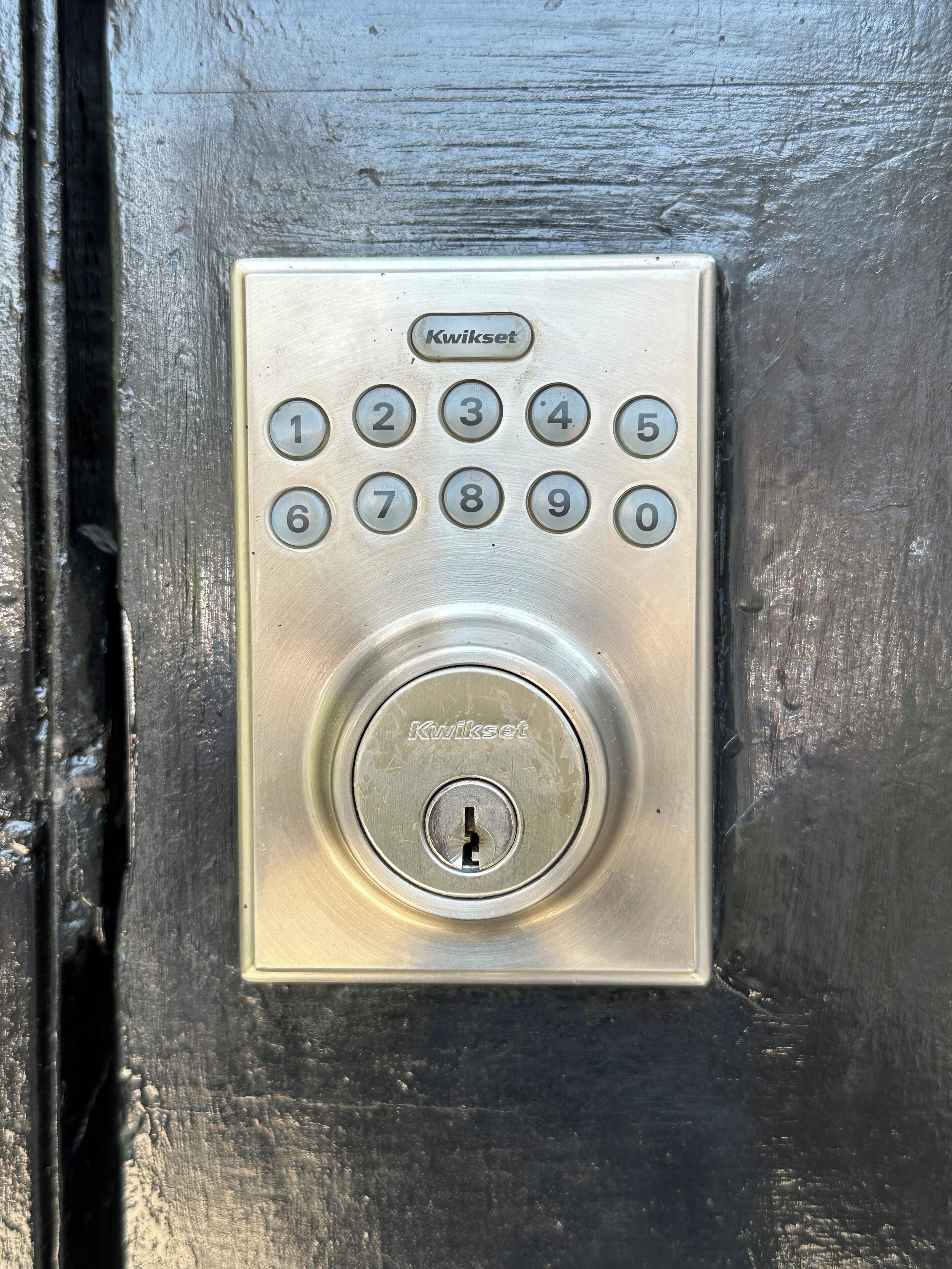 A Kwikset numeric keypad lock on a door.