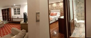 Relax in a stylish room with a large bed, bedside table, and television.