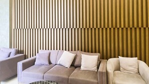 A modern living area with a sofa set against a textured wall. - HN APT Vinhomes D'capitale Elegance (Hanoi)