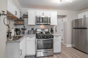 Enjoy cooking in this well-equipped kitchen with stainless steel appliances, a coffee bar, and a sink.
