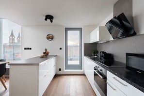 Deluxe Penthouse, City View | Private kitchen | Coffee/tea maker, paper towels, dining tables - Modern Penthouse with 3-bedrooms (Prague)
