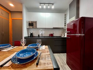 Fridge, microwave, coffee/tea maker, cookware/dishes/utensils