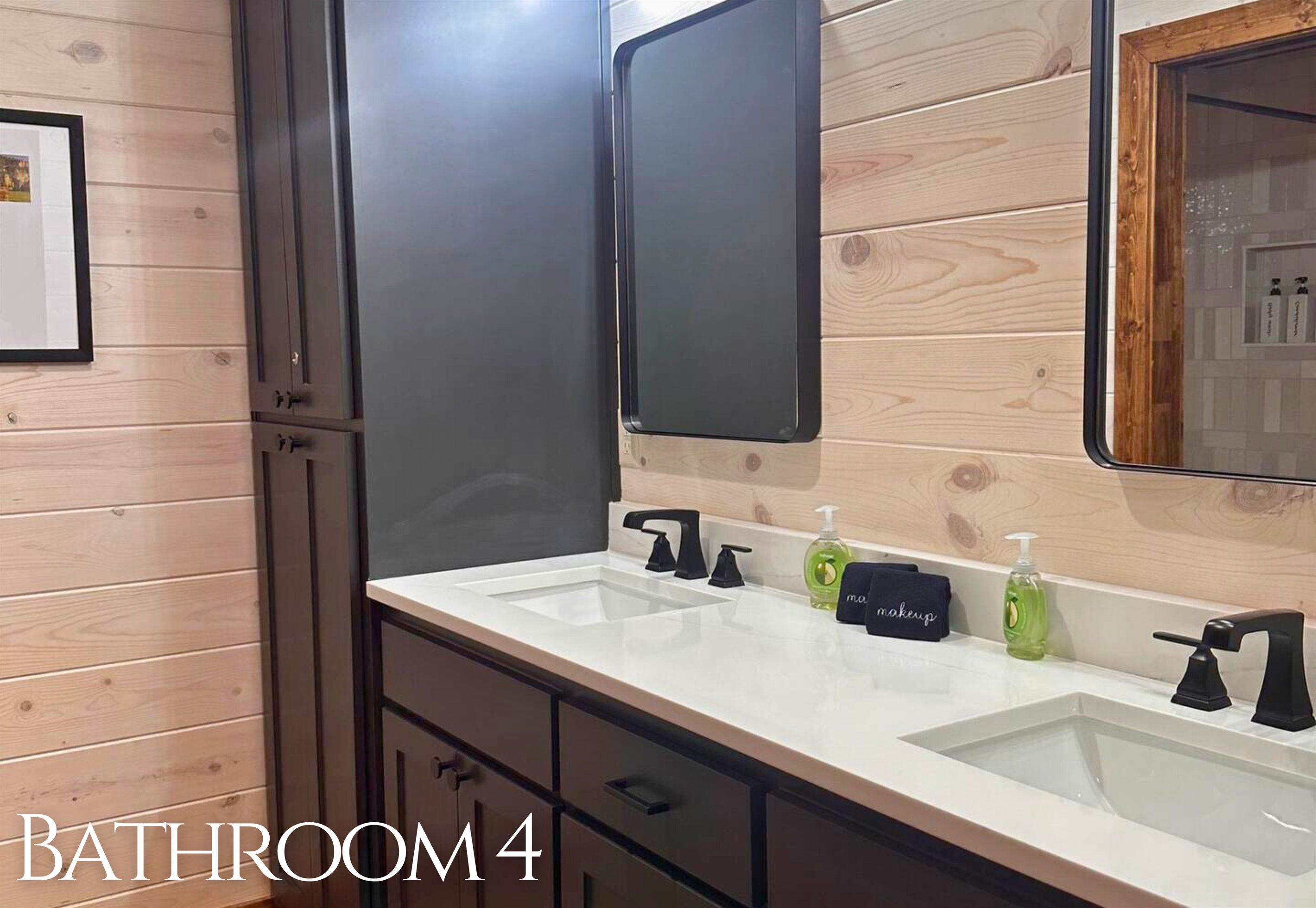A bathroom with two sinks, a mirror, and a cabinet.