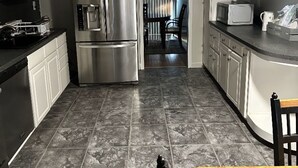 A modern kitchen with a stainless steel refrigerator, a microwave, and a dishwasher. - Spacious 4-bedroom house in nice Oxon Hill with WiFi, fitness room (Oxon Hill)