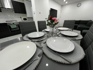 Enjoy meals in this dining area with a dining table for four, microwave, and oven.