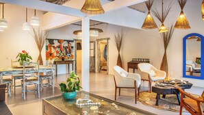 A modern interior with a dining area, seating, and decorative elements. - Awe Villa Boutique e Beach Club (Porto Seguro)