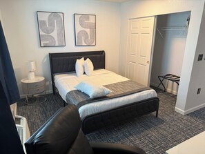 Desk, laptop workspace, iron/ironing board, bed sheets