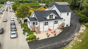 A two-story building with a driveway leading to a parking area.