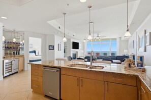 A modern kitchen with granite countertops, stainless steel appliances, and wooden cabinets.