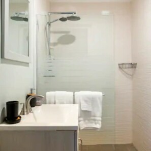 Shower, hair dryer, towels, toilet paper