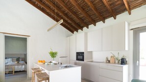 A modern kitchen with white cabinetry, a central island, and a wooden ceiling. - RURAL HOUSE CERCADO DE DON PACO (Santa Lucia De Tirajana (Capital Municipal))