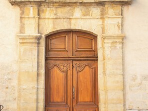 Stunning stone archway frames an ornate door with intricate carvings and a central handle.