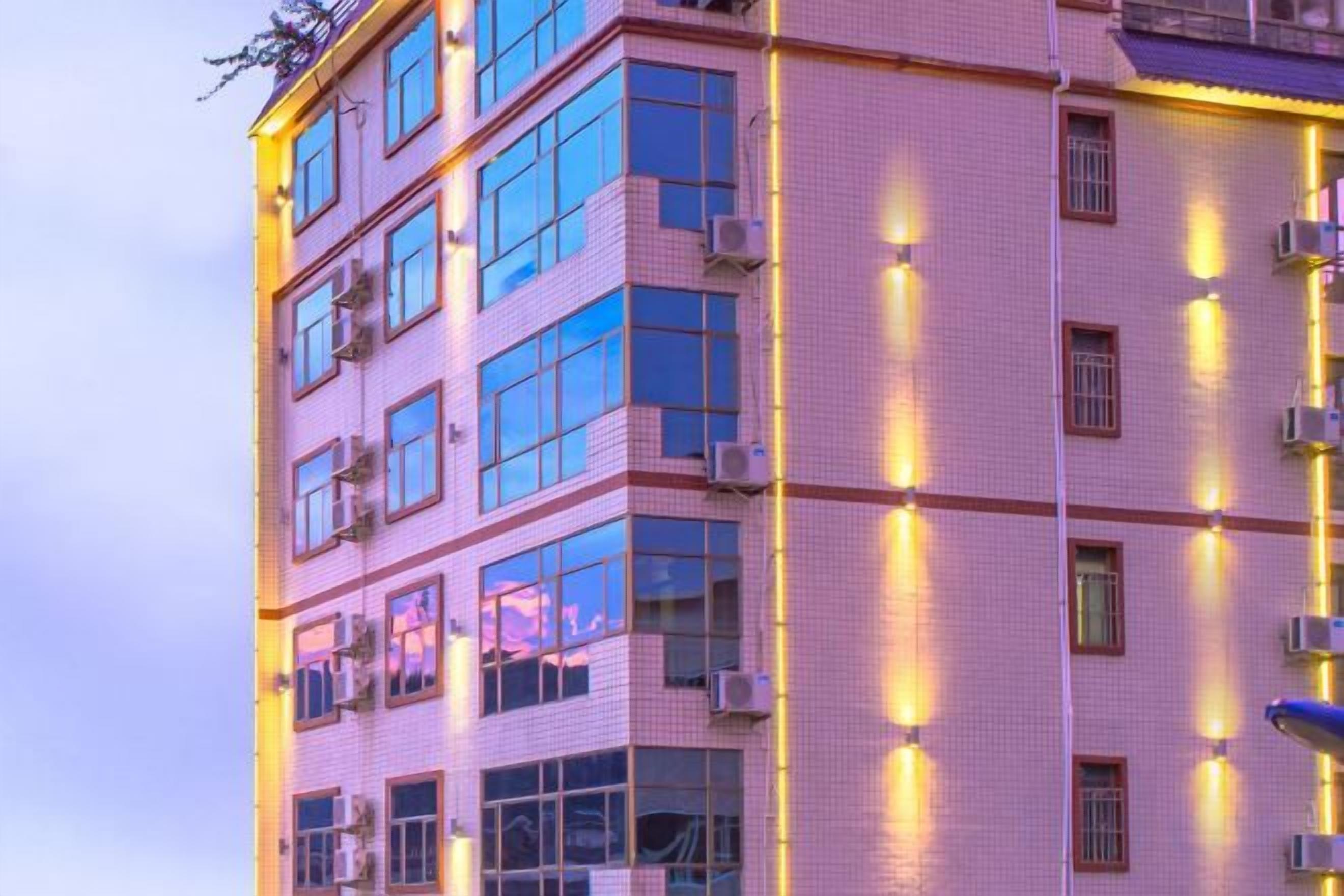 A multi-story building with a tiled facade and multiple windows.
