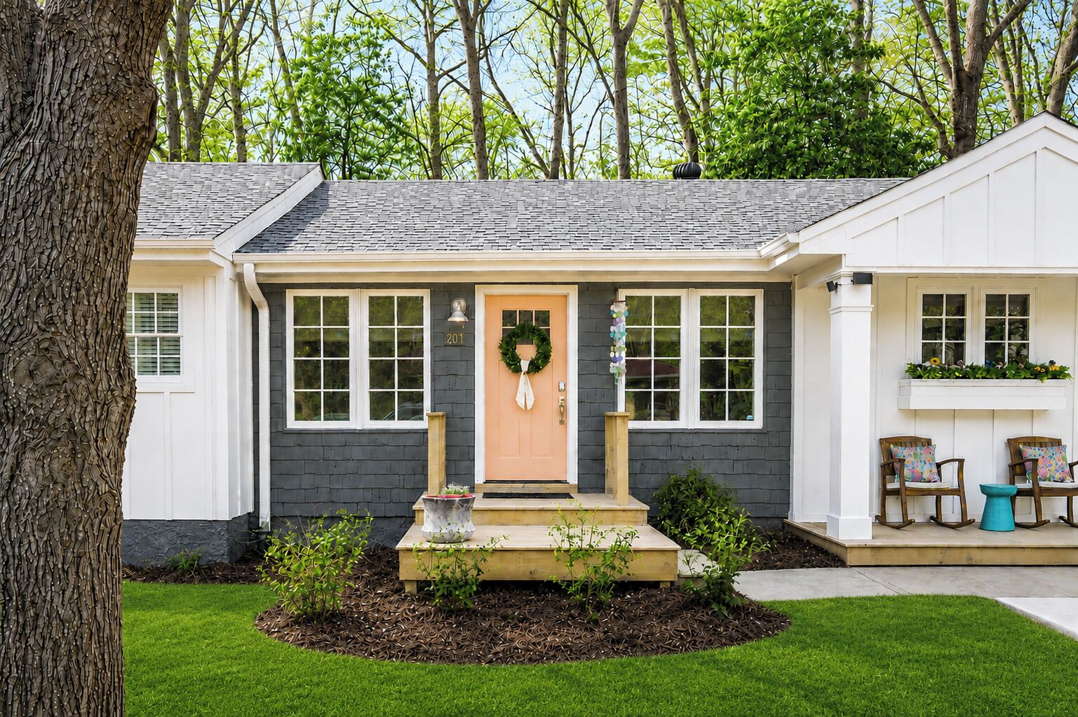 A house with a front porch, a door with a wreath, and a mailbox.