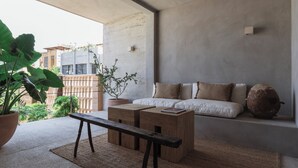 A modern living room with a sofa, wooden coffee table, and a bench.