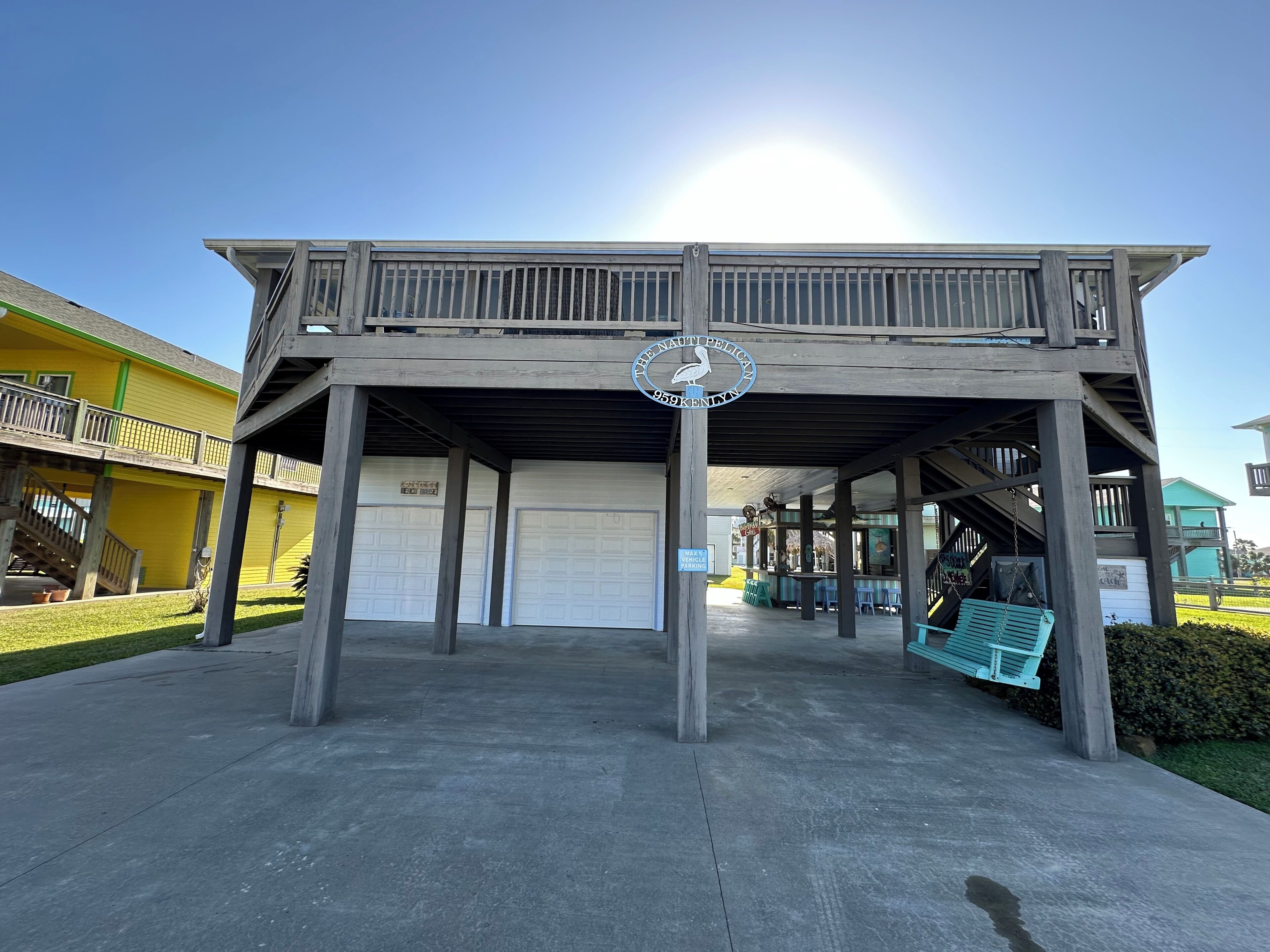 A wooden structure with a sign reading "The Nautical Pelican 959 Kenilworth" and a parking sign indicating "Walk's Vehicle Parking."