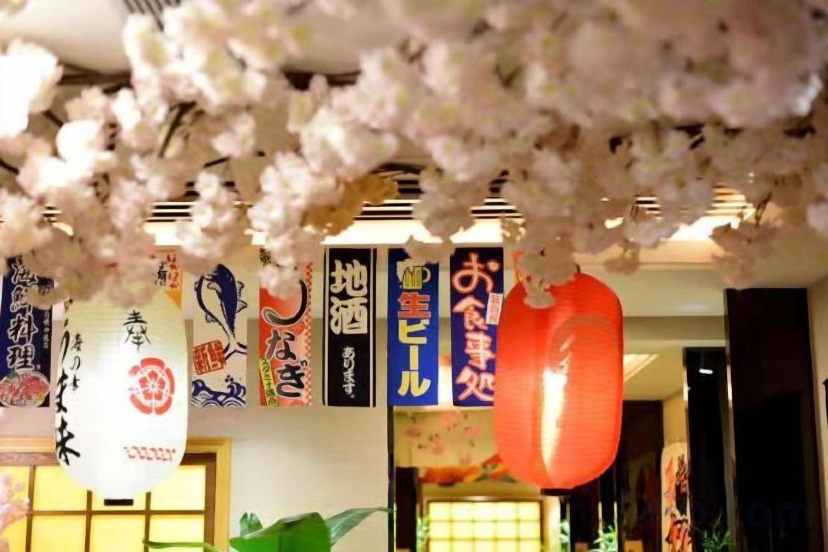 A traditional Japanese interior with hanging decorations and calligraphy.