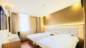 A hotel room with two beds, a desk, a mirror, and a window with curtains. - GreenTree Inn Shanghai Songjiang Xinqiao Jiuxin Road Express Hotel (Shanghai)