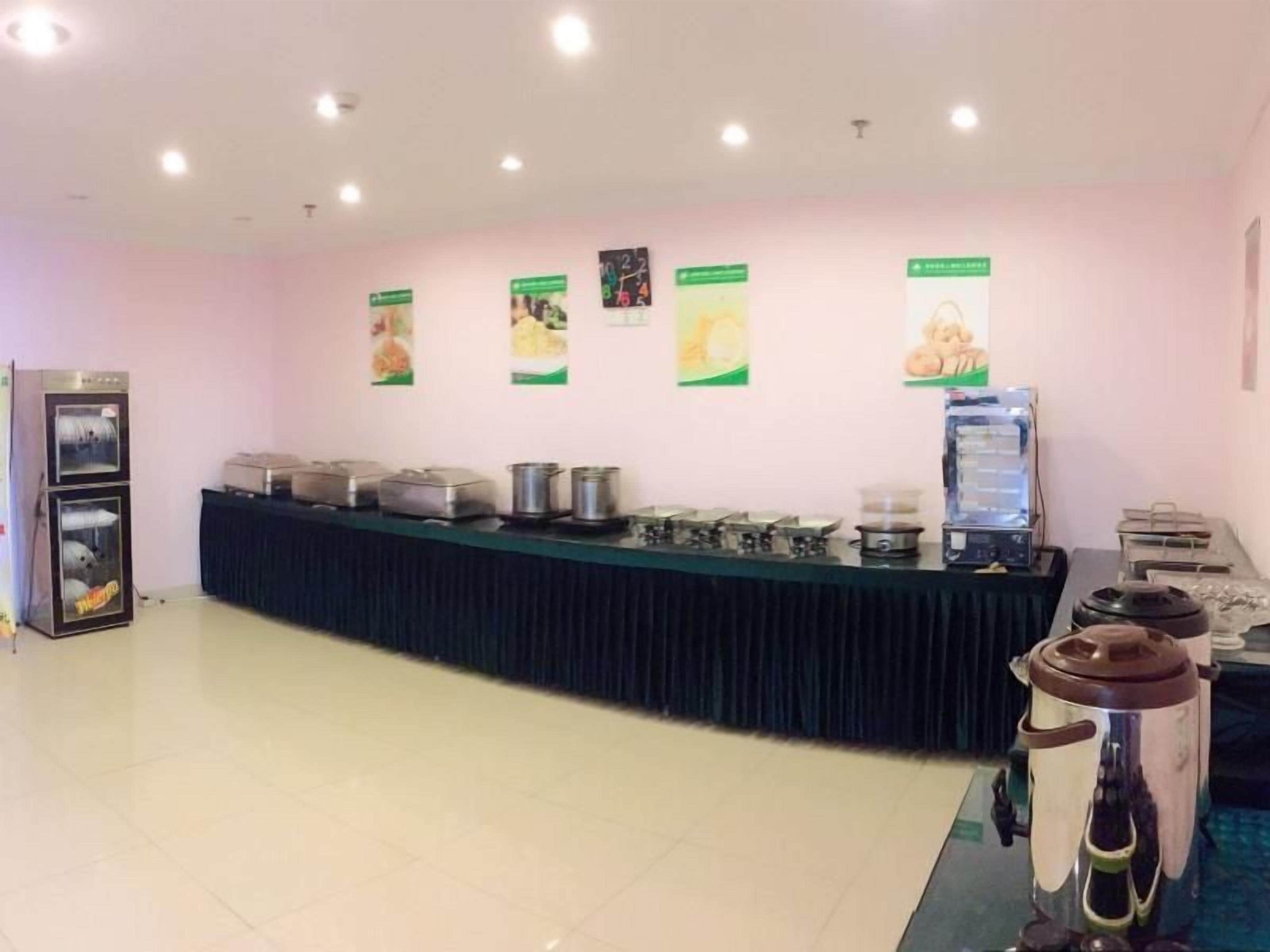 A buffet setup with a counter, food containers, and a water dispenser.