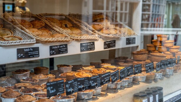 A bakery display with various pies and pastries, including Scotch Pie and Chicken & Egg Pie, priced at £2.60 each. - The Shambles – The Timbered Nest - A premium stay that sleeps 4 guests (York)
