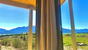 A wooden structure with a view of mountains and a lake. - Serene Retreat - Te Anau Holiday Home (Te Anau)