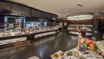 A buffet area with multiple food stations and a variety of dishes.