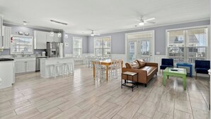 A spacious living area with a kitchen, dining area, and seating space.