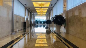A long, polished hallway with reflective floors and ceiling lights. - Metropark Hotel Yancheng (Yancheng)