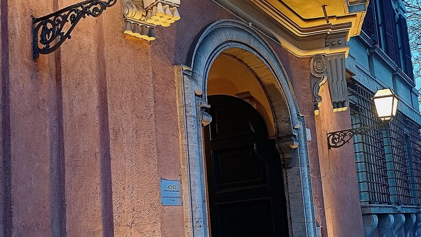 A building entrance with a dark door, ornate lamp posts, and a sign indicating the name and address. - Miriam's little house in Piazza di Spagna, an oasis of elegance in the heart of Rome (Roma)