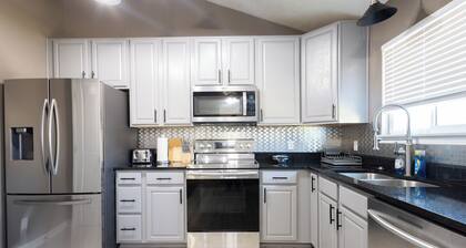 Spacious 4 bedroom house with AC, WiFi in, 2 living rooms, fenced, 2 car garage.