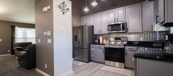 Spacious 4 bedroom house with AC, WiFi in, 2 living rooms, fenced, 2 car garage.