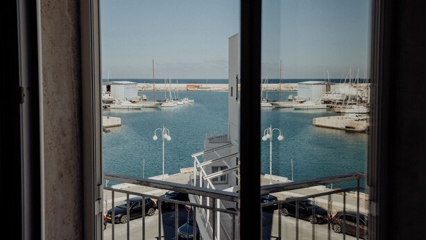 A marina with boats docked, a clear sky, and a view of the sea. - Fari by Monholiday - One Bedroom Apartment, Sleeps 4 (Monopoli)