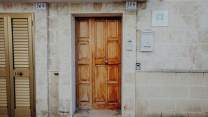 A wooden door with a metal handle, flanked by two signs indicating room numbers 36 and 38. - Fari by Monholiday - One Bedroom Apartment, Sleeps 4 (Monopoli)